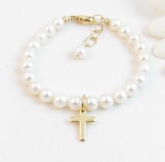 "A classic real freshwater pearl bracelet with gold-filled cross charm for a little girl, tween or teen. It is created with Grade-A 5.5mm freshwater pearls, a 14K gold-filled cross charm, and a 14K gold-filled oval lobster clasp with a 14K gold-filled 1/2\" \"Grow with Me\" extender chain. You choose where the cross charm is placed - near the clasp or in the front/center (as shown). All metal components are 14K gold-filled. Cross measures 1/2\" tall and 3/8\" wide. Arrives packaged in my signatu Real Pearl Bracelet, 2023 Wishlist, Pearl Charm Bracelet, Baby Bracelet, Baptism Girl, Freshwater Pearl Bracelet, Confirmation Gifts, Real Pearls, Pearl Charms