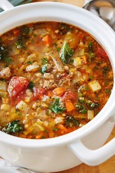 a white bowl filled with soup on top of a wooden table