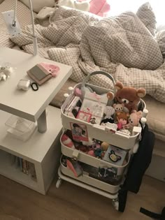 a bed with a white table and some stuffed animals