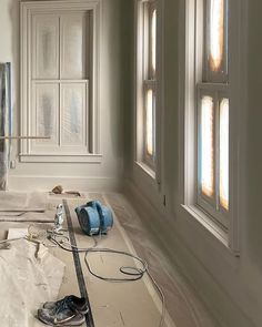 the interior of a house being remodeled with white walls and windows in place for painting