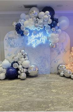 balloons and streamers are set up in front of a backdrop for a birthday party