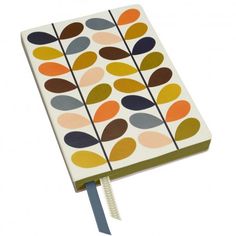 an open notebook with colorful leaves on the front and side, tied to a cord