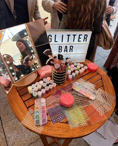 a table that has various items on it and a sign with the word glitter bar