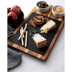 an assortment of cheeses and crackers on a cutting board