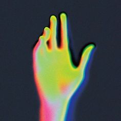 a person's hand that is glowing brightly in the dark, with only one finger visible