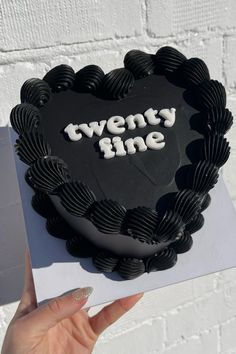 there is a heart shaped cake with the words twenty nine on it and an envelope