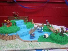 a birthday cake that is shaped like a farm scene