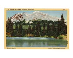 a postcard with a mountain in the background and trees on the bank below it