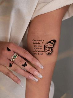 a woman's arm with a butterfly tattoo on it