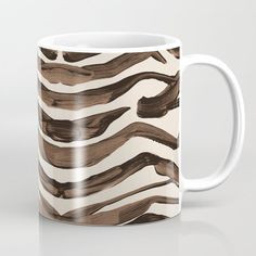 a coffee mug with brown and white wavy lines on the outside, in front of a gray background