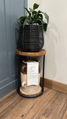 a potted plant sitting on top of a wooden stand