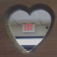 an exit sign in the shape of a heart