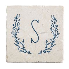 a stone coaster with the letter s on it