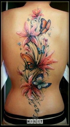 the back of a woman's body with butterflies on it and flowers in the middle