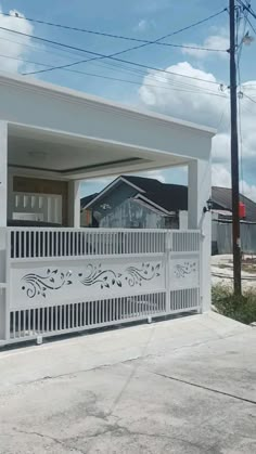 a house with a white fence and some houses in the background