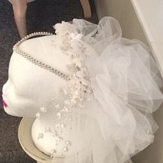 a white mannequin wearing a wedding dress and headpiece