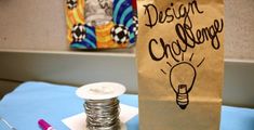 a brown paper bag sitting on top of a table next to stacks of silver coins