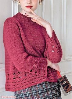 a woman in a red sweater is posing for the camera with her hand on her chin