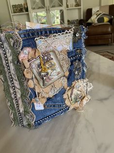 a purse made out of old jeans with laces and buttons on the inside is sitting on a table