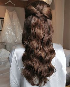 the back of a woman's head with long wavy hair