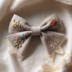 a close up of a bow tie on a white cloth