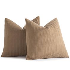 two brown pillows sitting next to each other