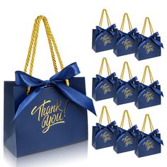 six blue gift bags with gold handles and ribbons tied around them that say thank you