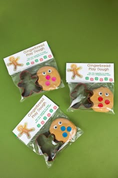 three gingerbread play doughs in cellophane bags on a green table top