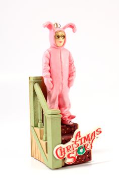 a figurine wearing a pink bunny suit standing on top of a set of stairs