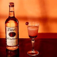 a bottle of tio's cinnamon soda next to a small glass filled with liquid