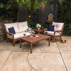 two chairs and a coffee table on a patio