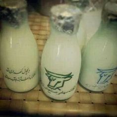 four empty milk bottles sitting next to each other