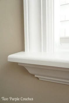 a white window sill sitting next to a window