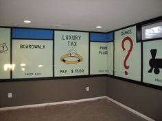 an empty room with posters on the wall and carpeted flooring in front of it