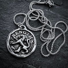 This Johnny LTD design features a wax seal medal of the mighty lion, which symbolizes strength. Wear this necklace as a reminder of the inner strength you possess, or give this as a meaningful gift. The necklace is available in 20 to 24 inches in length and looks great in an open collared shirt or over a t-shirt.Pendant Material: PewterNecklace Material: Stainless Steel ChainNecklace Clasp: LobsterNecklace Length: 20 to 24 inchesPendant Dimensions: 25 x 27mm (1 in x 1.06 in)General Care: We sele Lion Strength, Seal Necklace, Wax Seal Necklace, Vintage Gentleman, Lion Necklace, Stainless Steel Chain Necklace, Pewter Pendant, Necklace Clasps, Antique Pewter