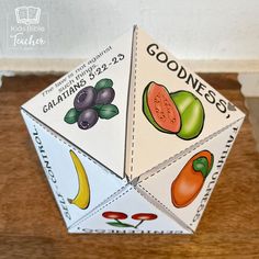 an origami fruit and vegetable box on a wooden table with the words goodbye written in it