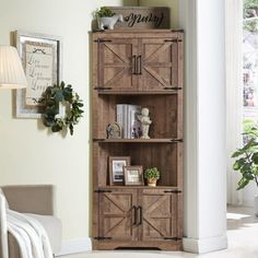 a wooden bookcase sitting in the corner of a living room