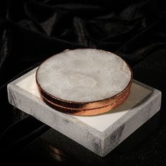 a white and gold plate sitting on top of a marble block