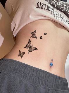 a woman's stomach with butterflies on it