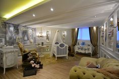 a living room filled with lots of furniture and decor on top of hard wood flooring