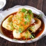 a bowl filled with food on top of a wooden table