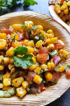 corn salad with cilantro and parsley in a wooden bowl