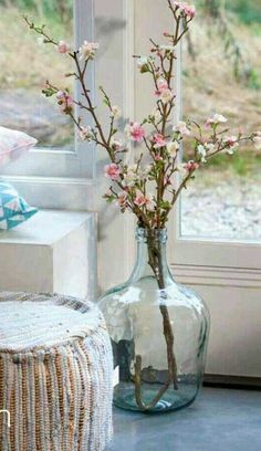 a vase filled with flowers next to a window