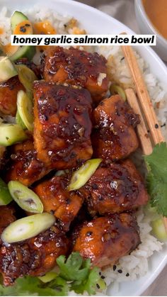 a bowl filled with meat and vegetables on top of rice next to chopsticks