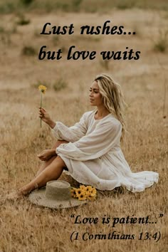 a woman sitting in a field holding a flower with the words, just wishes but love waits