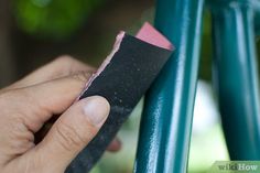 a hand holding a piece of black and pink material