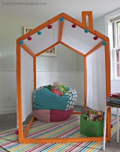 a child's play tent in the corner of a room