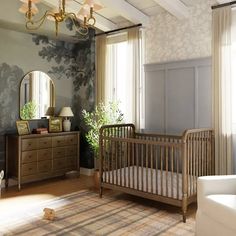 a baby's room with a crib, dresser and mirror