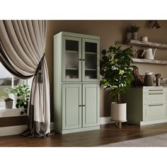 a green cabinet sitting next to a window in a room with wooden floors and walls