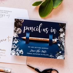 two wedding stationery cards with pencils on them